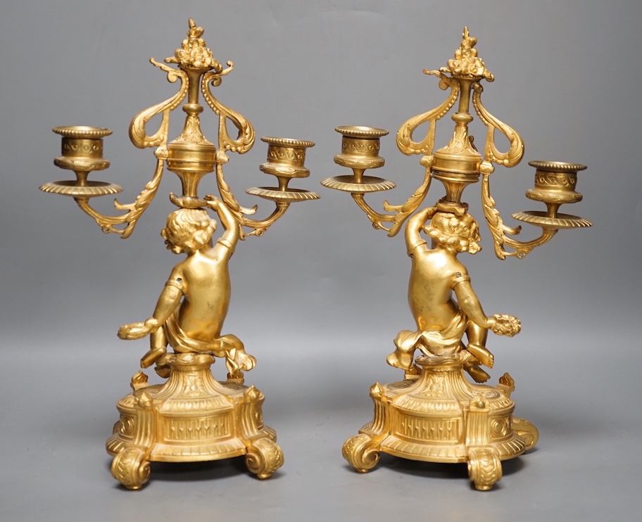 A pair of Louis XVI style ormolu cherub candelabra, late 19th century, 31cm